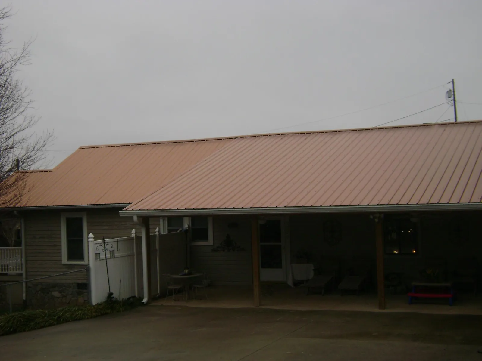Copper toned metal roof over a wide covered patio in Londonderry